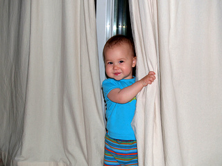 child vanishes behind curtain