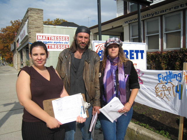 group including Brian Caldwell in front of MPP Toby Barrett's office