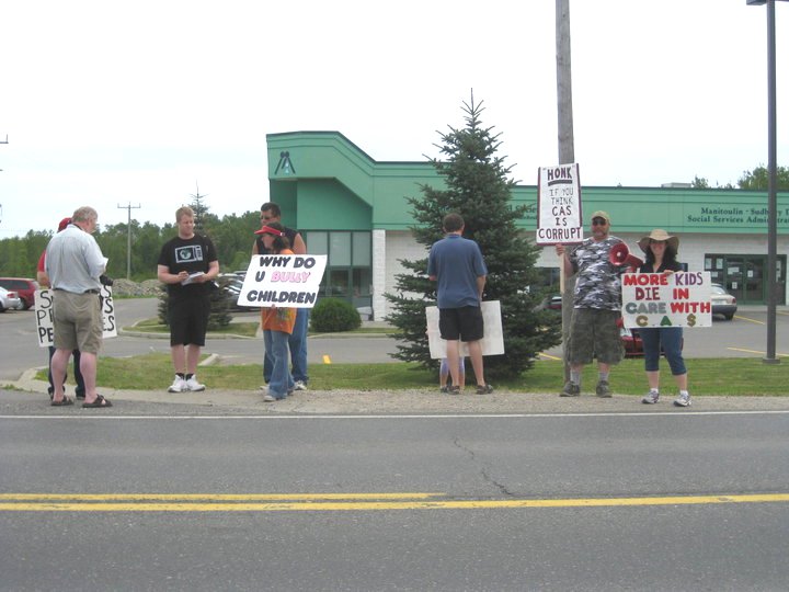 Reporters interview ralliers outside Little Current CAS office