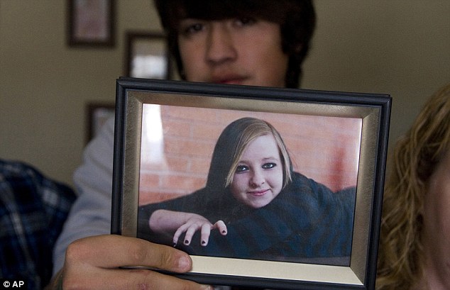 Nathan Wittman holds photo of Jenni Lake