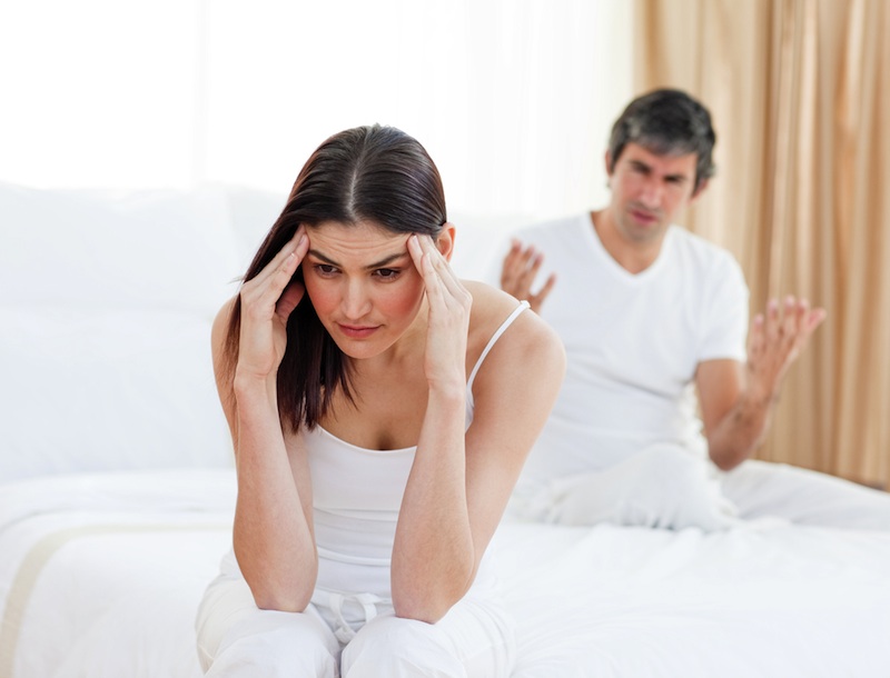 distressed couple in bed