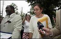 Carline VandenElsen walks to a 
                walks to a relative's vehicle
                after being released on bail in July.
